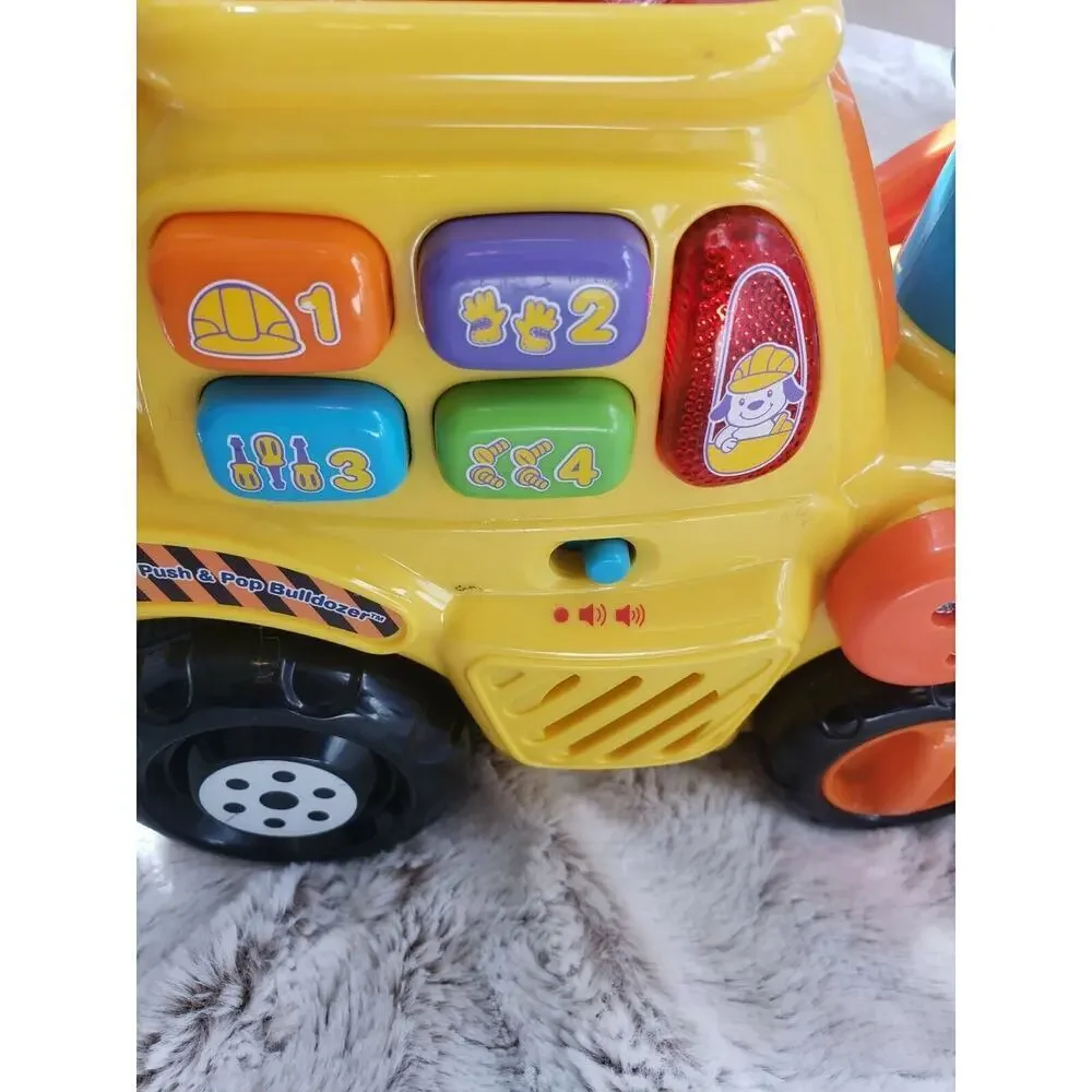 V TECH PUSH AND POP MUSICAL BULLDOZER